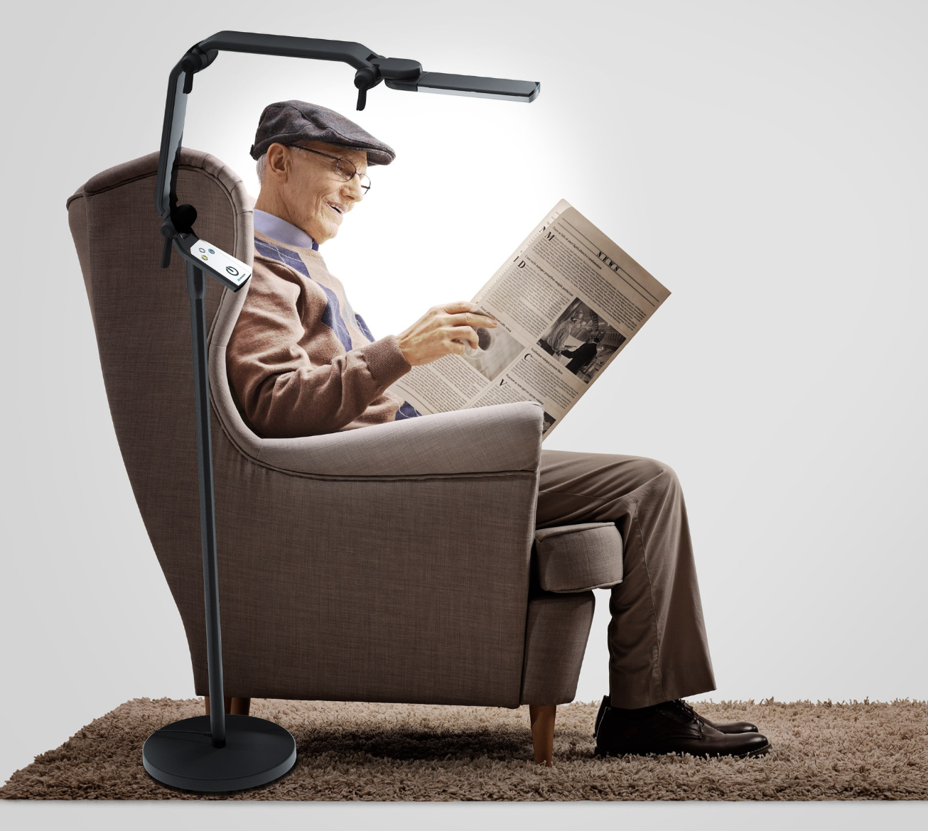 Man using floor lamp to read newspaper