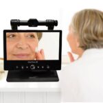 An elderly lady using the Clearview Go to apply make up