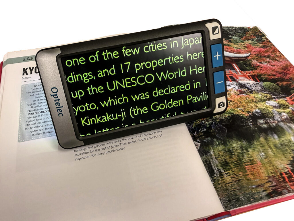 Compact Go on a travel book, the image on screen is enlarged and refers to some text about Kyoto