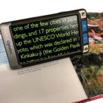 Compact Go on a travel book, the image on screen is enlarged and refers to some text about Kyoto